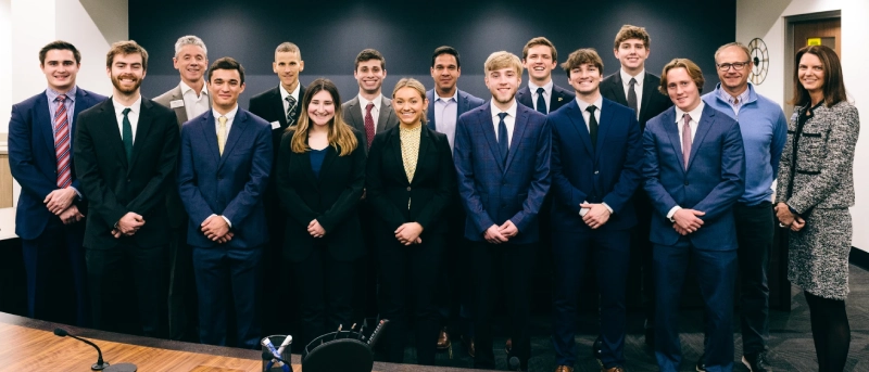 group of students wearing suits