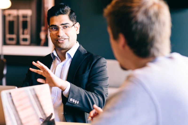 Student wearing suit in conversation
