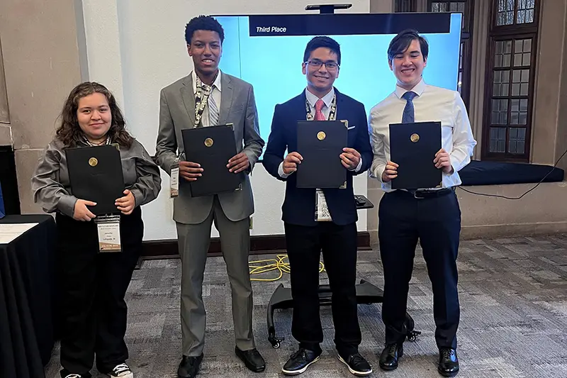 A group of students with awards from case competition