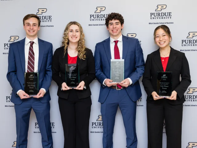 Four students holding trophies