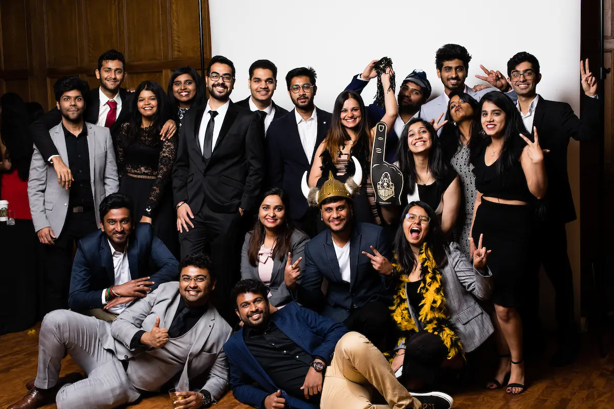 Masters graduate pose for a fun celebratory photo