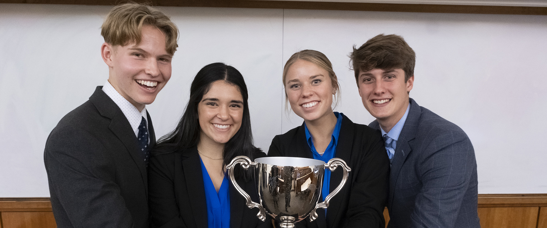 Students with trophy at case competition