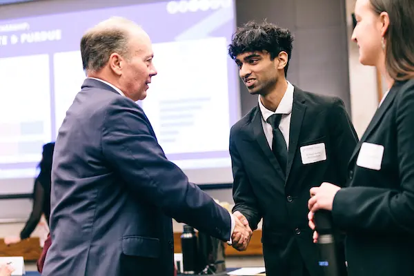Business student shaking hands with industry leader