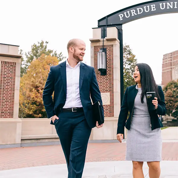 Two Ph.D. students walk on campus
